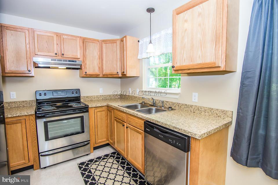 29890 Deal Island Road Princess Anne, MD 21853 - Photo 7 of 32 a kitchen with a stove a sink and a window