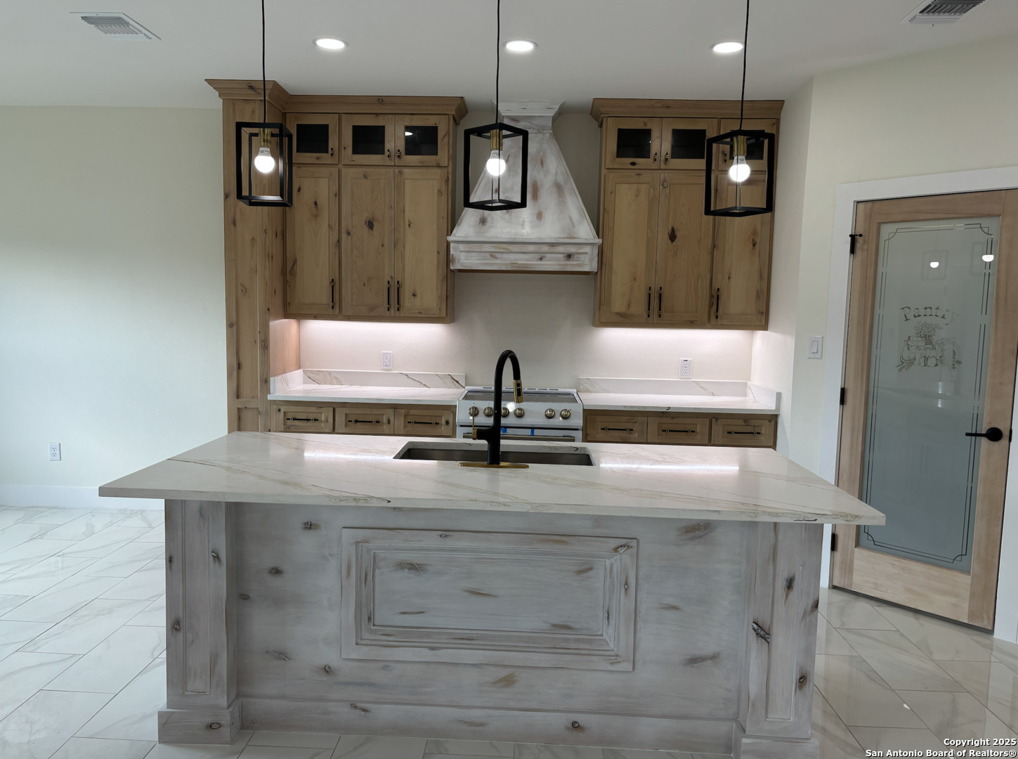 809 North Camp Street Uvalde, TX 78801 - Photo 12 of 30 a kitchen with cabinets and outdoor space