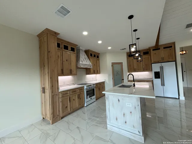 a kitchen with a sink and cabinets