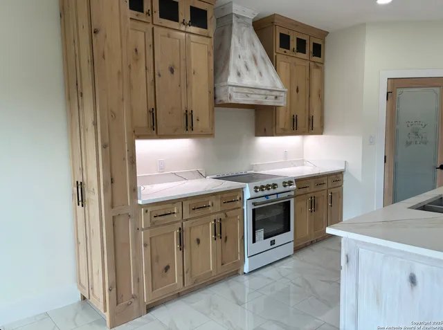 a kitchen with stainless steel appliances granite countertop a stove and a refrigerator