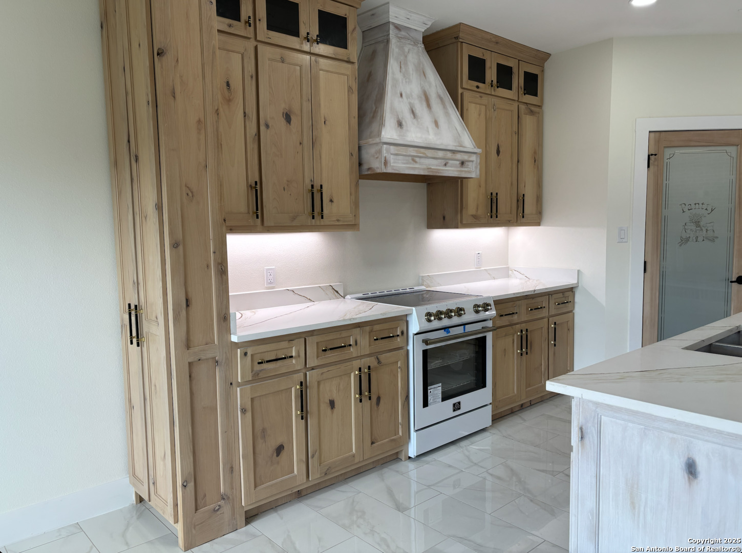 809 North Camp Street Uvalde, TX 78801 - Photo 14 of 30 a kitchen with stainless steel appliances granite countertop a stove and a refrigerator