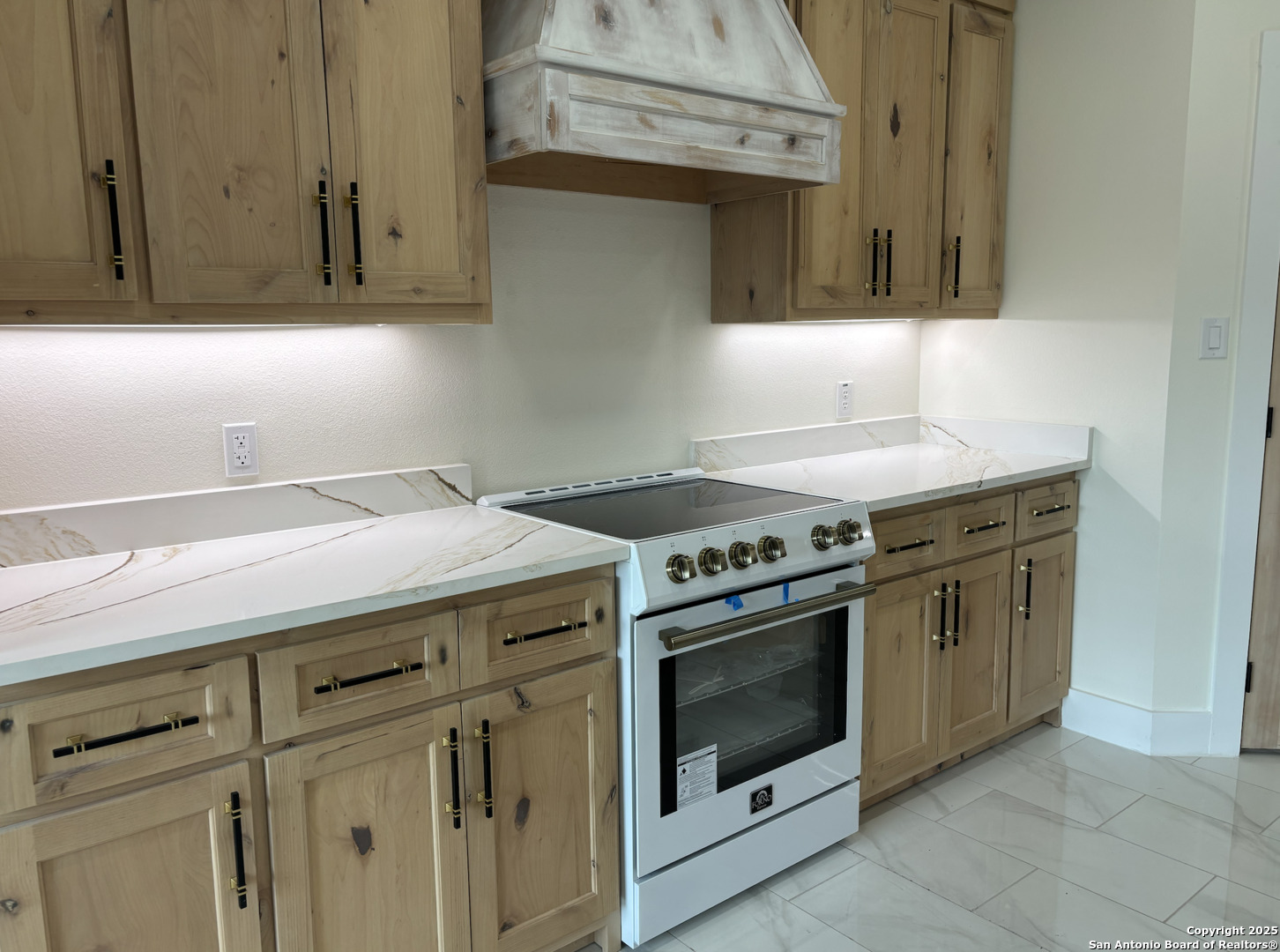 809 North Camp Street Uvalde, TX 78801 - Photo 15 of 30 a kitchen with stainless steel appliances granite countertop a stove and a microwave
