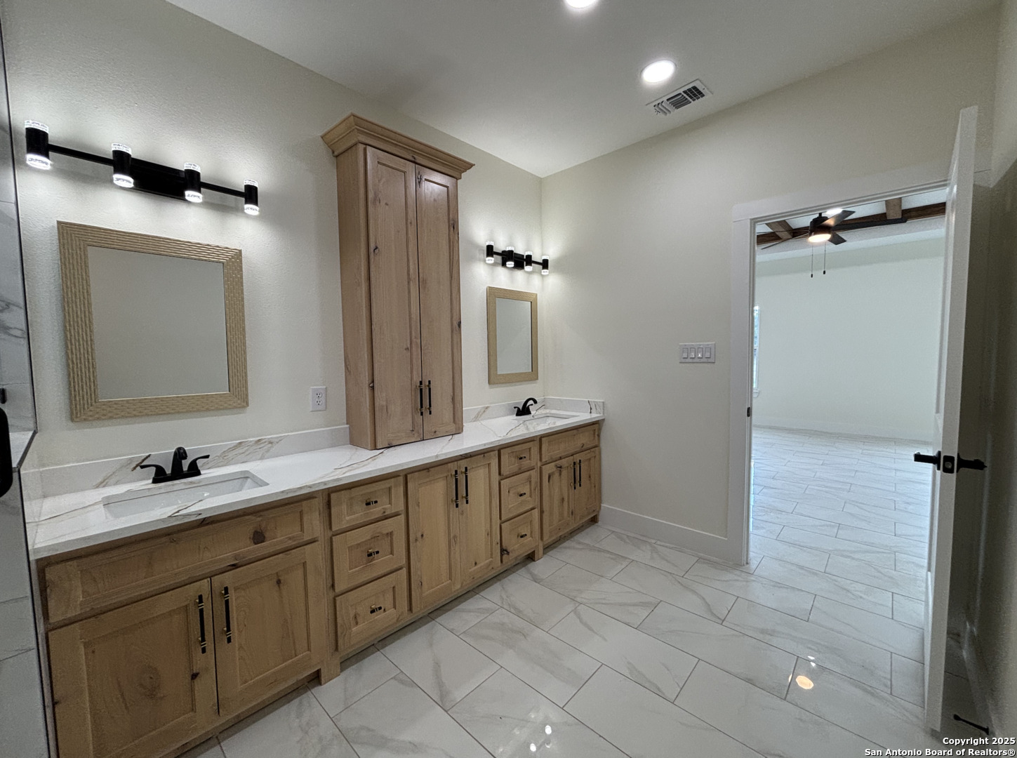 809 North Camp Street Uvalde, TX 78801 - Photo 18 of 30 a spacious bathroom with a double vanity sink mirror and double