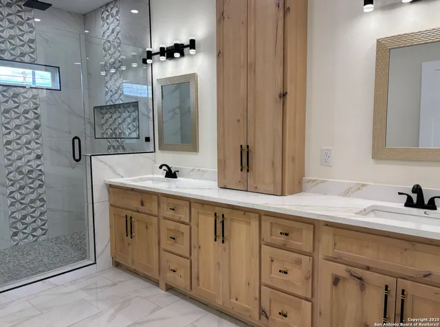a spacious bathroom with double sink and a mirror