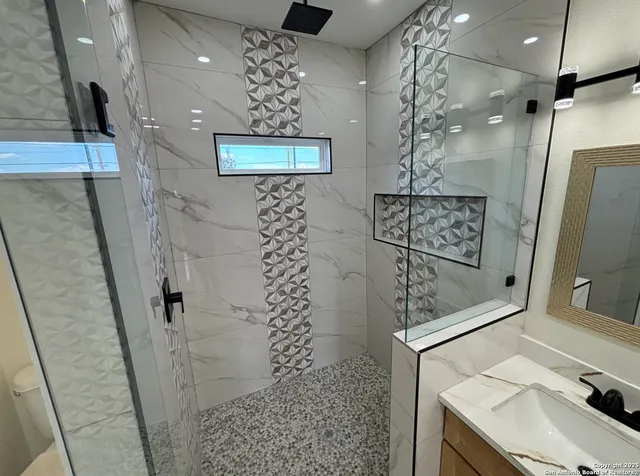 a bathroom with a sink and mirror