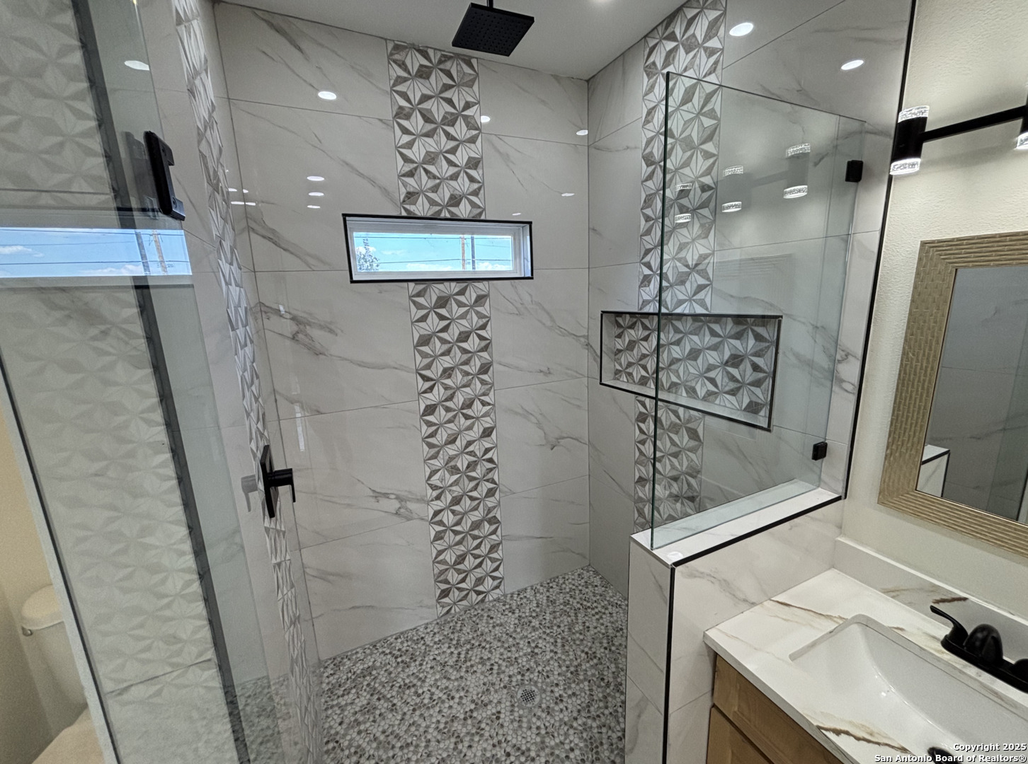809 North Camp Street Uvalde, TX 78801 - Photo 21 of 30 a bathroom with a sink and mirror