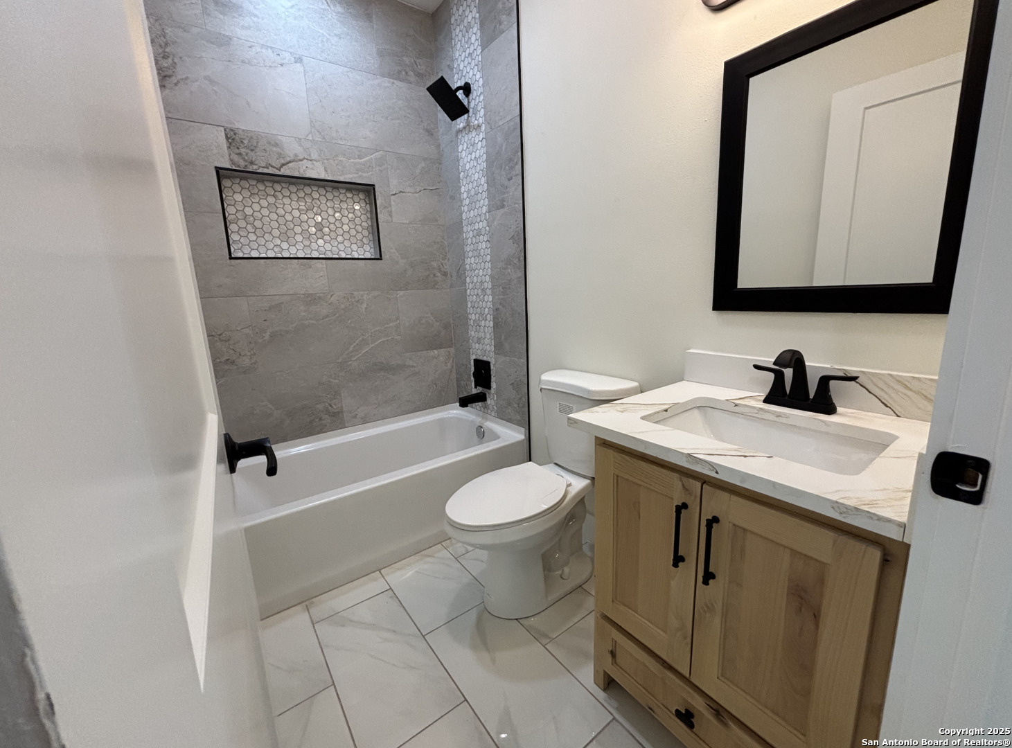 809 North Camp Street Uvalde, TX 78801 - Photo 29 of 30 a bathroom with a granite countertop sink toilet a mirror and shower