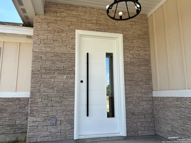 a view of a door and chair in a room