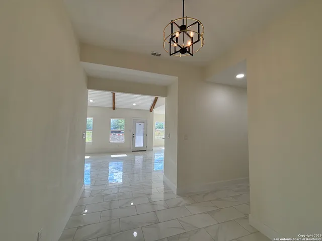 a view of a hallway with chandelier