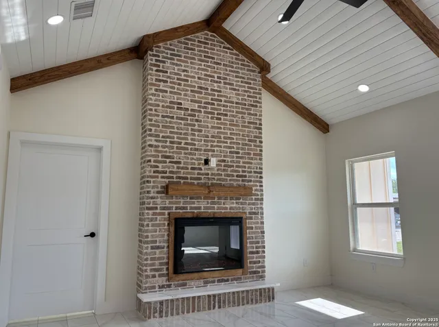 a view of an empty room with a fireplace