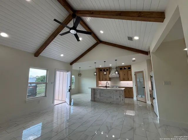 a view of kitchen with refrigerator and window