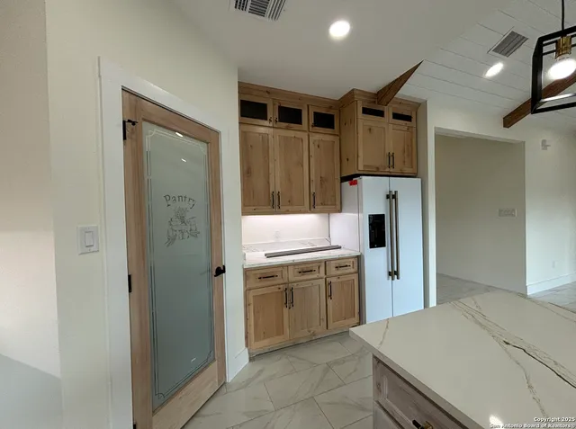 a kitchen with a refrigerator and a sink
