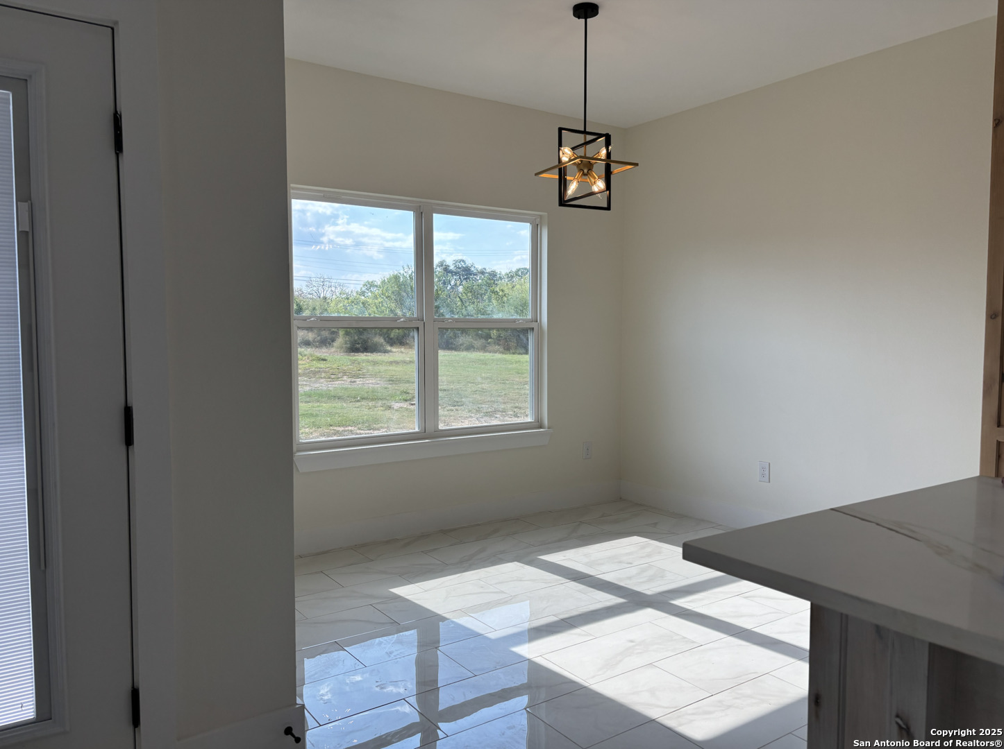809 North Camp Street Uvalde, TX 78801 - Photo 10 of 30 a view of a room with a window and wooden floor