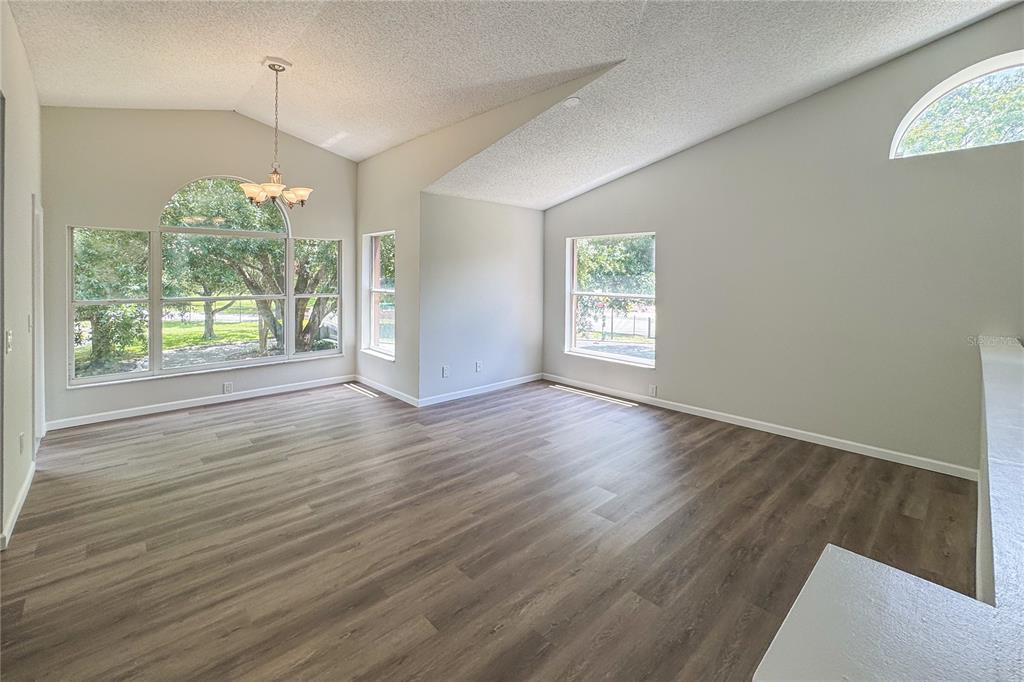 5436 East Michigan Street, Unit 4 Orlando, FL 32812 - Photo 2 of 37 an empty room with wooden floor and windows