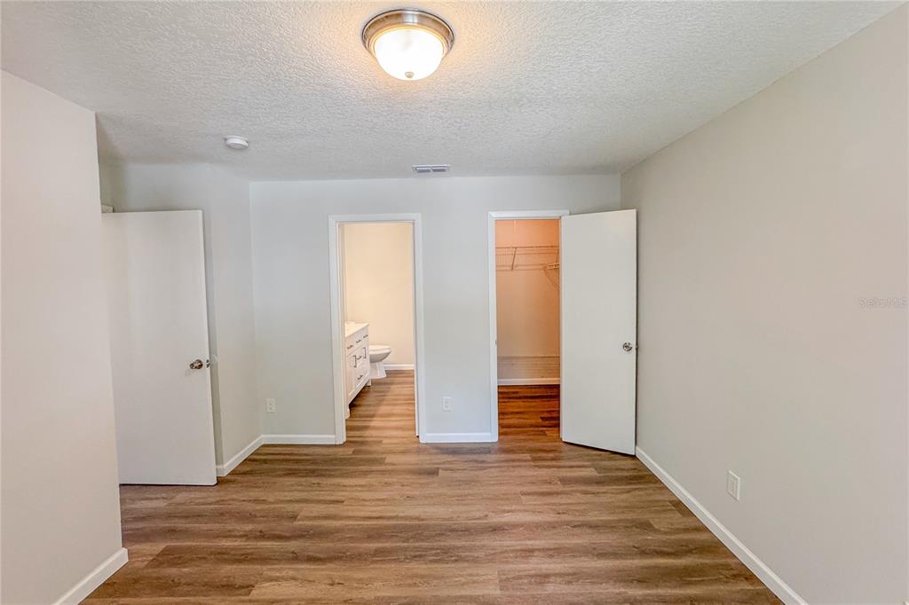 5436 East Michigan Street, Unit 4 Orlando, FL 32812 - Photo 21 of 37 an empty room with wooden floor and windows
