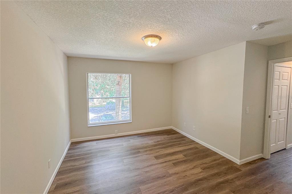 5436 East Michigan Street, Unit 4 Orlando, FL 32812 - Photo 22 of 37 an empty room with wooden floor and windows