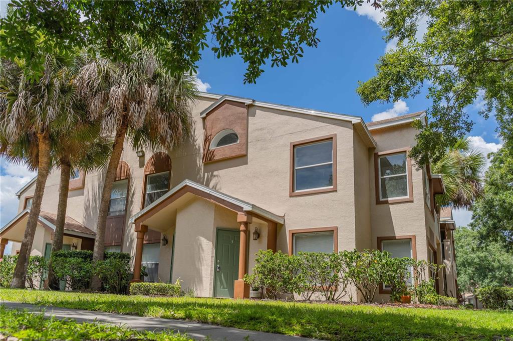 5436 East Michigan Street, Unit 4 Orlando, FL 32812 - Photo 33 of 37 a front view of a house with a yard