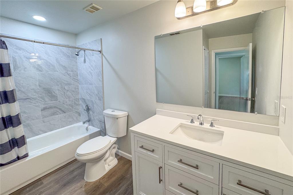 5436 East Michigan Street, Unit 4 Orlando, FL 32812 - Photo 6 of 37 a bathroom with a sink a toilet and shower