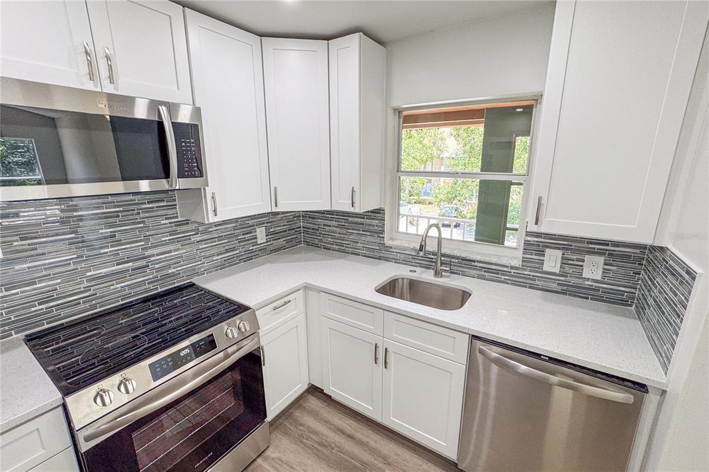 5436 East Michigan Street, Unit 4 Orlando, FL 32812 - Photo 9 of 37 a kitchen that has a sink and a stove
