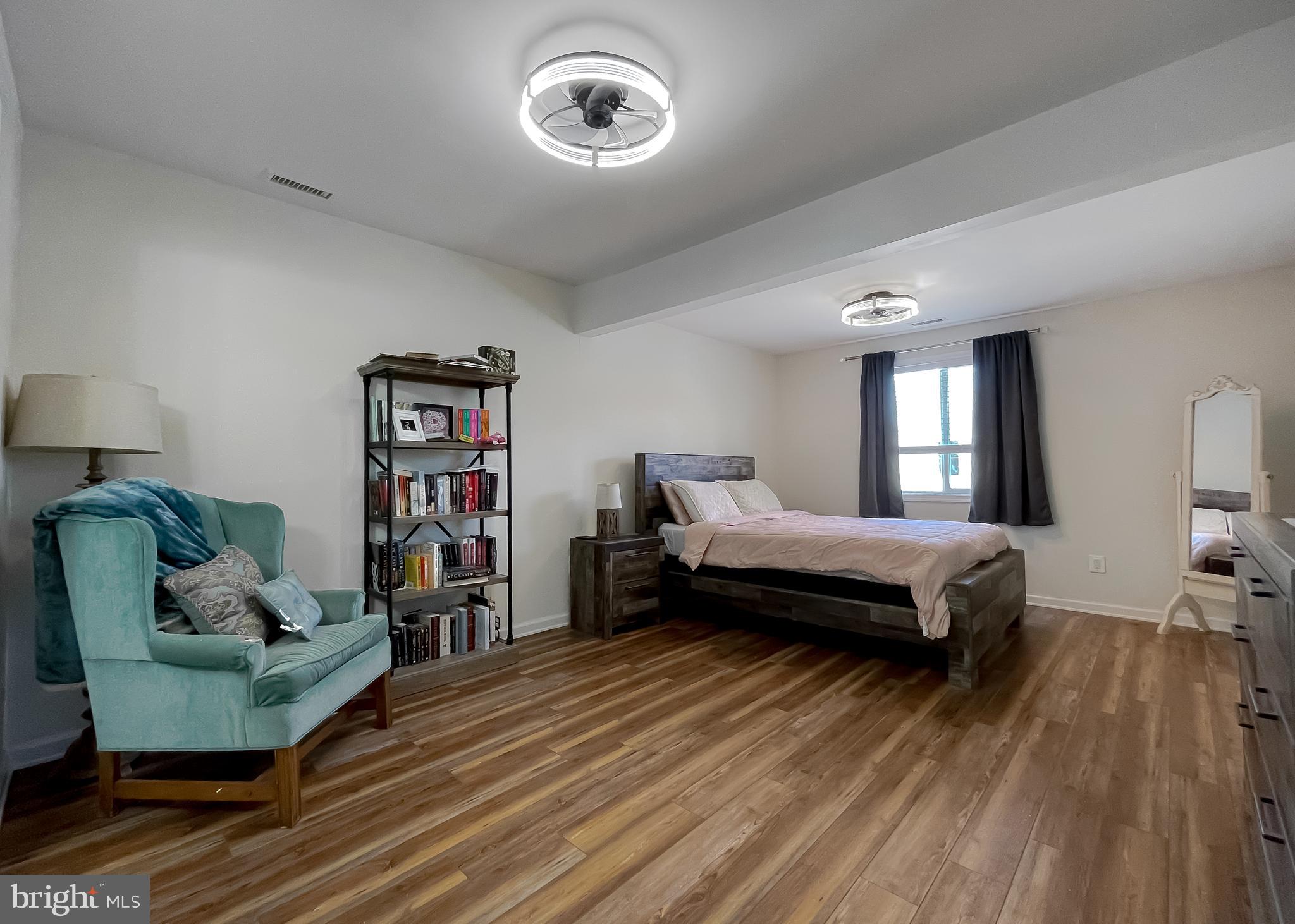 17262 Larimer Street Piney Point, MD 20674 - Photo 15 of 44 a spacious bedroom with a bed and a couch