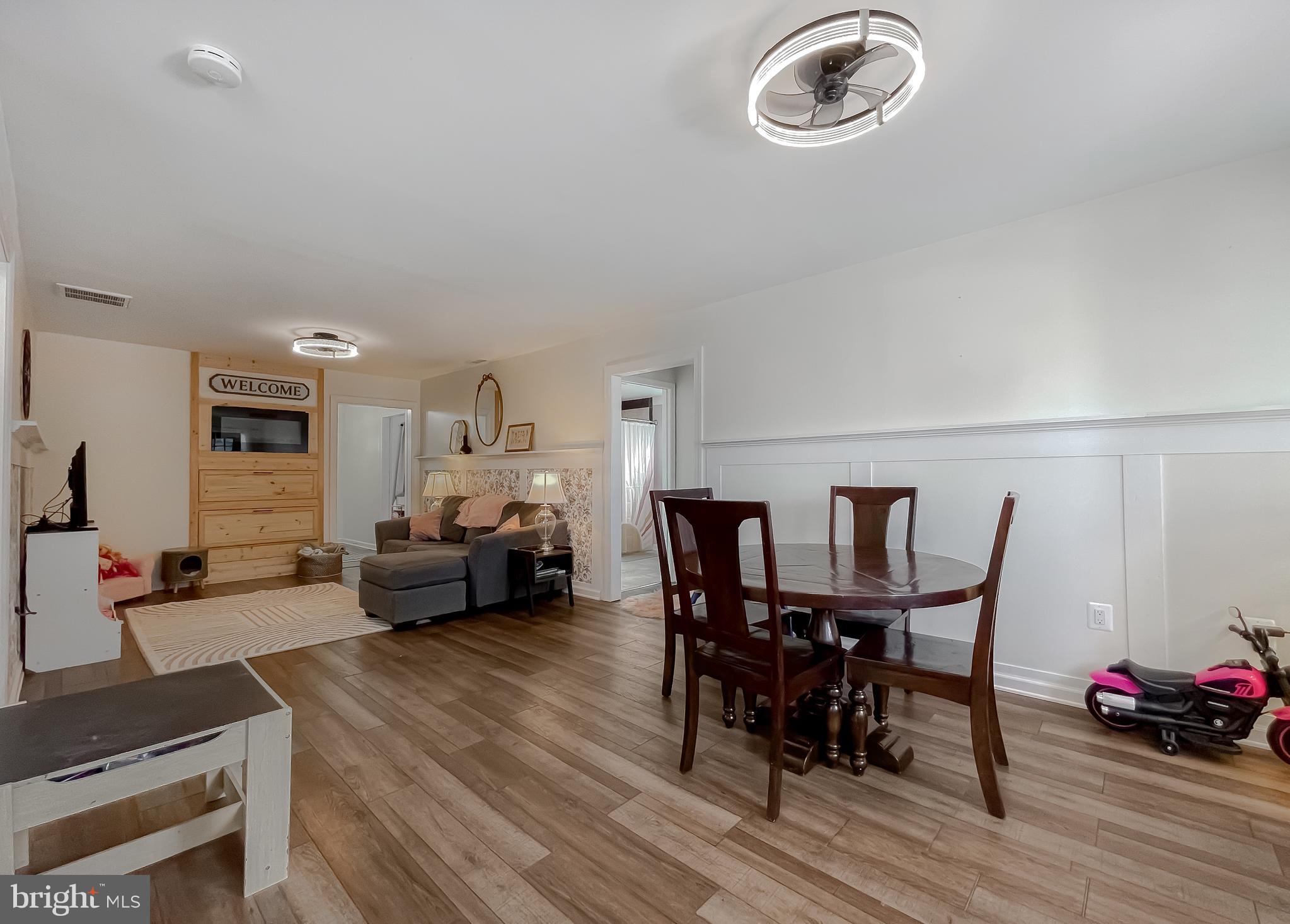 17262 Larimer Street Piney Point, MD 20674 - Photo 4 of 44 a view of a dining room with furniture and wooden floor