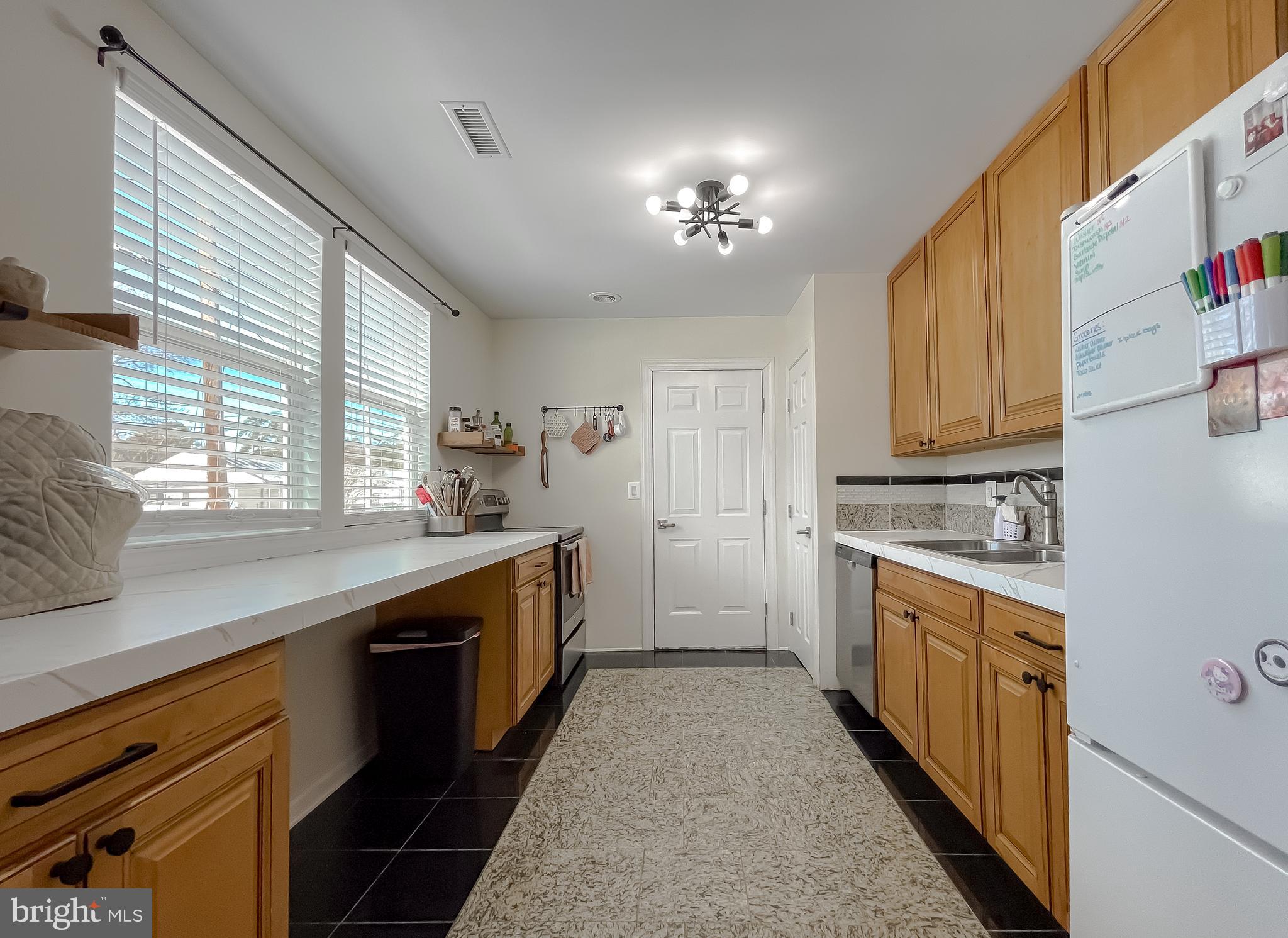 17262 Larimer Street Piney Point, MD 20674 - Photo 5 of 44 a kitchen with a stove top oven sink and cabinets