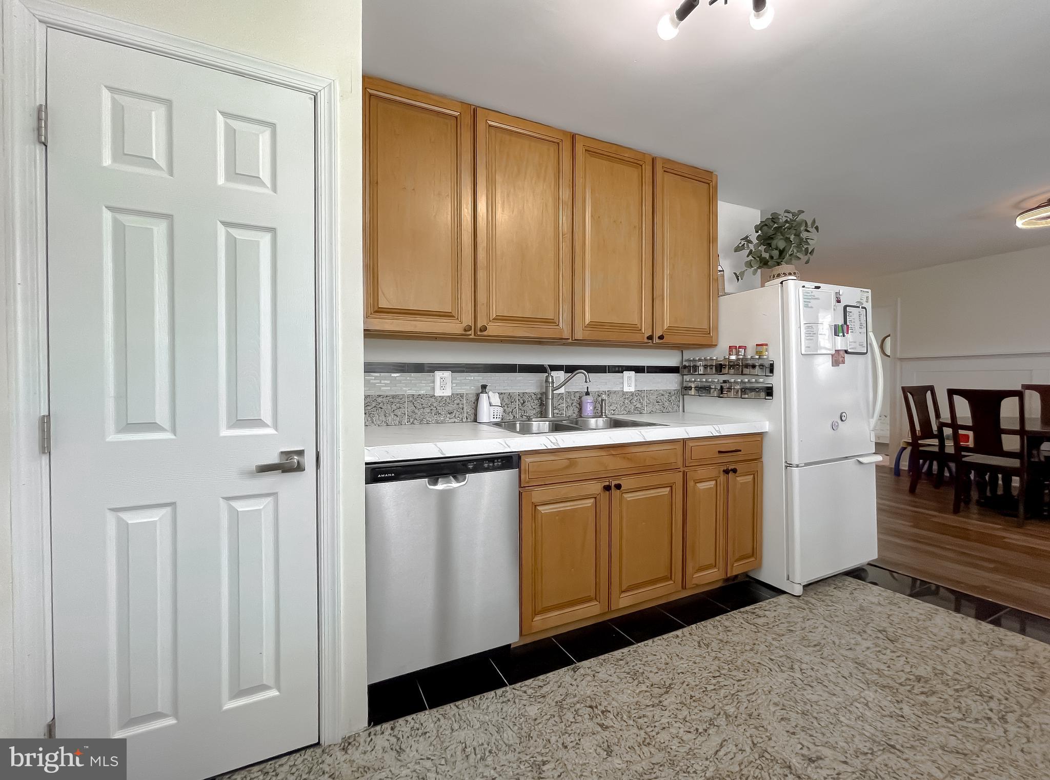17262 Larimer Street Piney Point, MD 20674 - Photo 7 of 44 a kitchen with cabinets and white appliances