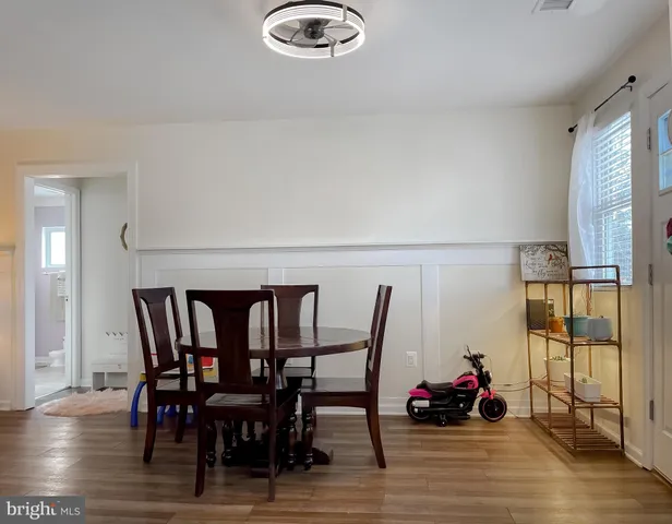 a living room with furniture a clock and a table