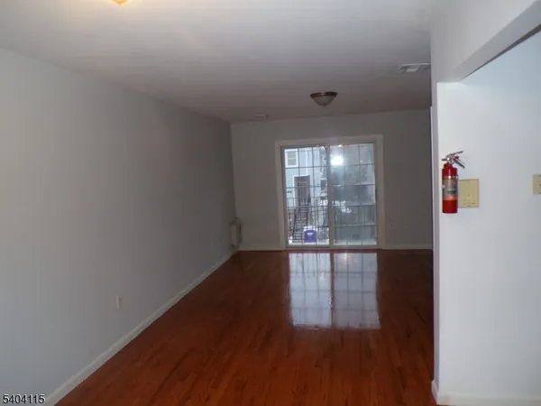 a view of hallway with wooden floor