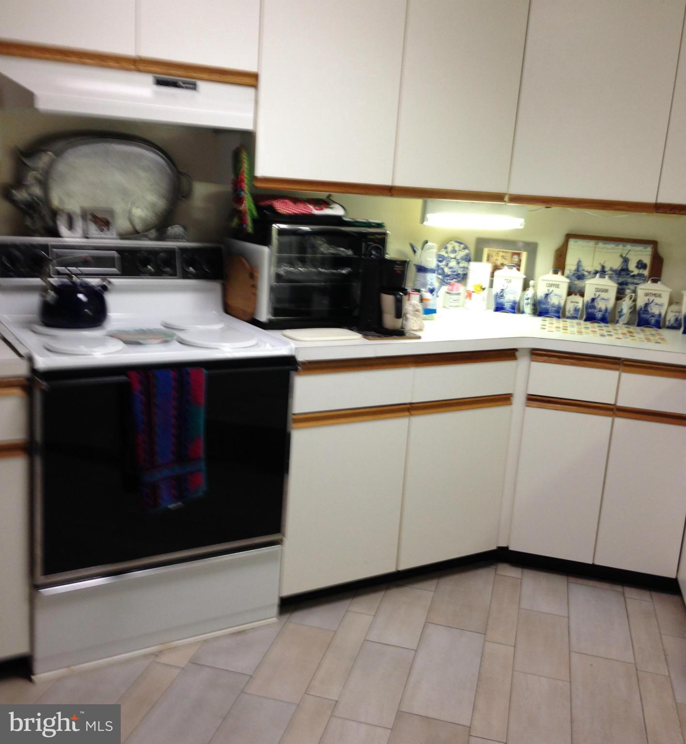 3011 Fallstaff Road, Unit 107A Baltimore, MD 21209 - Photo 3 of 14 a kitchen with granite countertop a sink and a stove