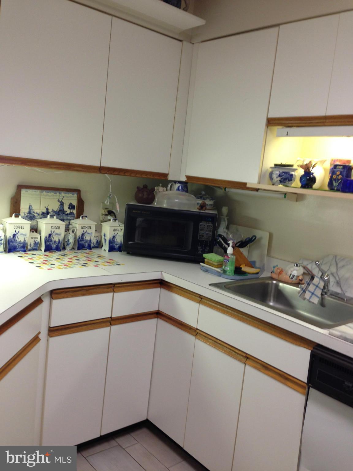 3011 Fallstaff Road, Unit 107A Baltimore, MD 21209 - Photo 4 of 14 a kitchen with a sink and cabinets