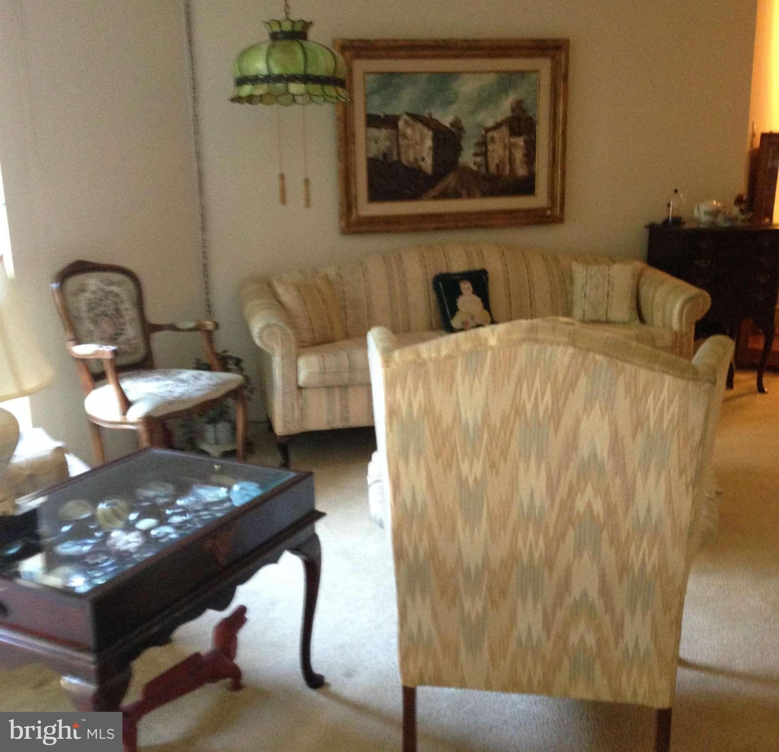 3011 Fallstaff Road, Unit 107A Baltimore, MD 21209 - Photo 6 of 14 a living room with furniture and wooden floor