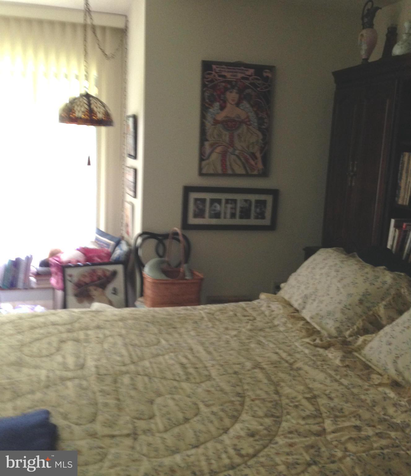3011 Fallstaff Road, Unit 107A Baltimore, MD 21209 - Photo 8 of 14 a bedroom with a bed and a table