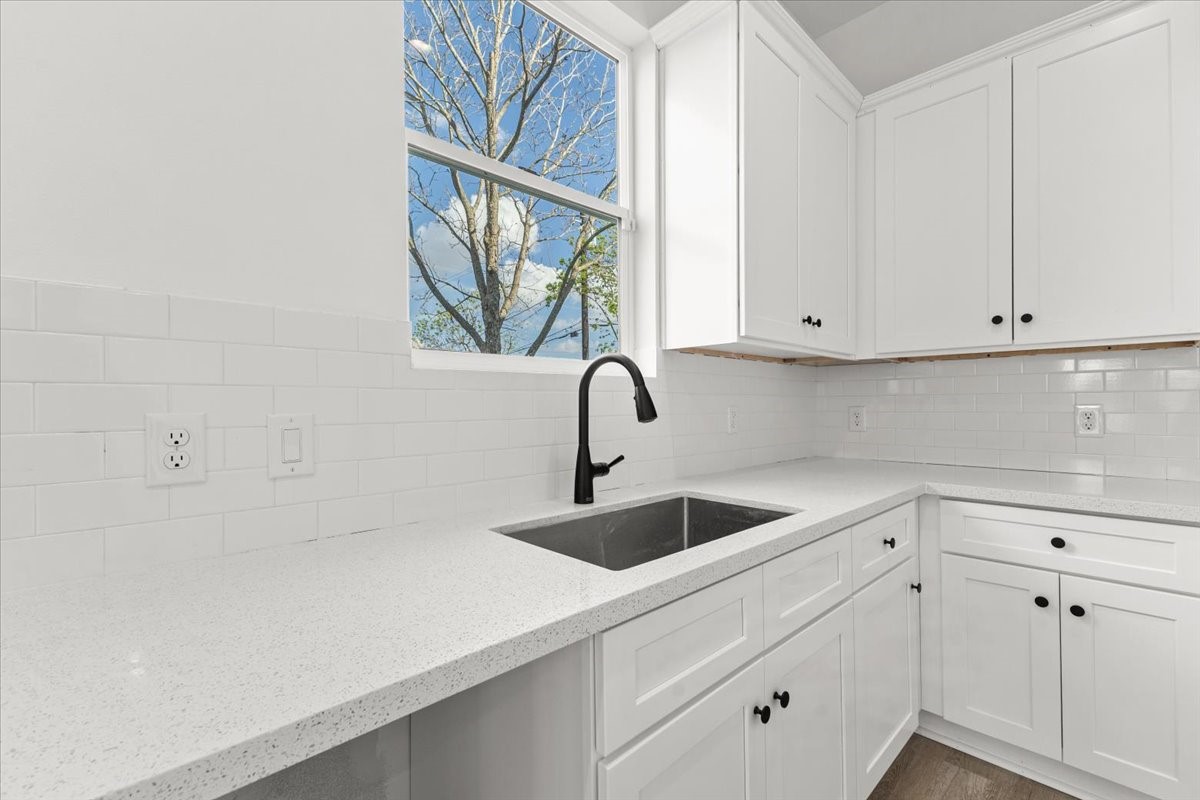 311 Tennessee Street Houston, TX 77029 - Photo 11 of 38 a kitchen with white cabinets and a sink