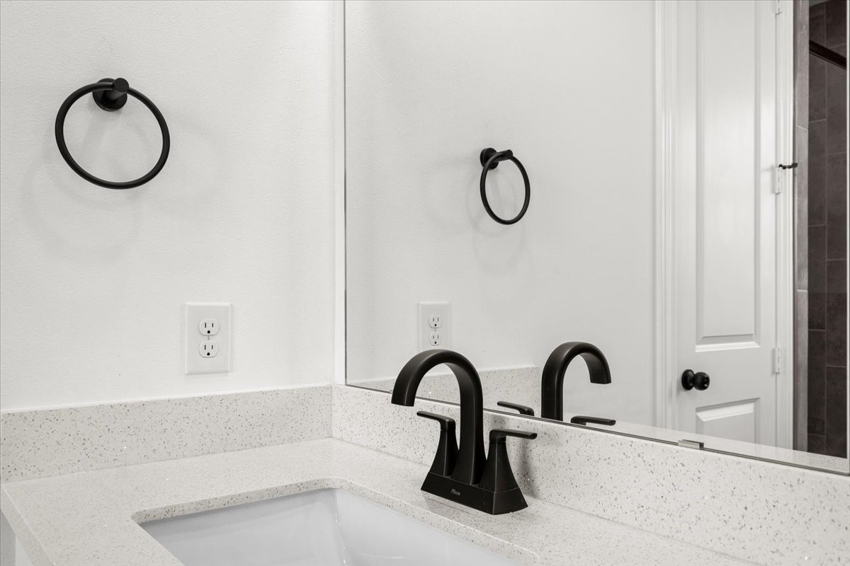 311 Tennessee Street Houston, TX 77029 - Photo 19 of 38 a bathroom with a granite countertop sink and a mirror
