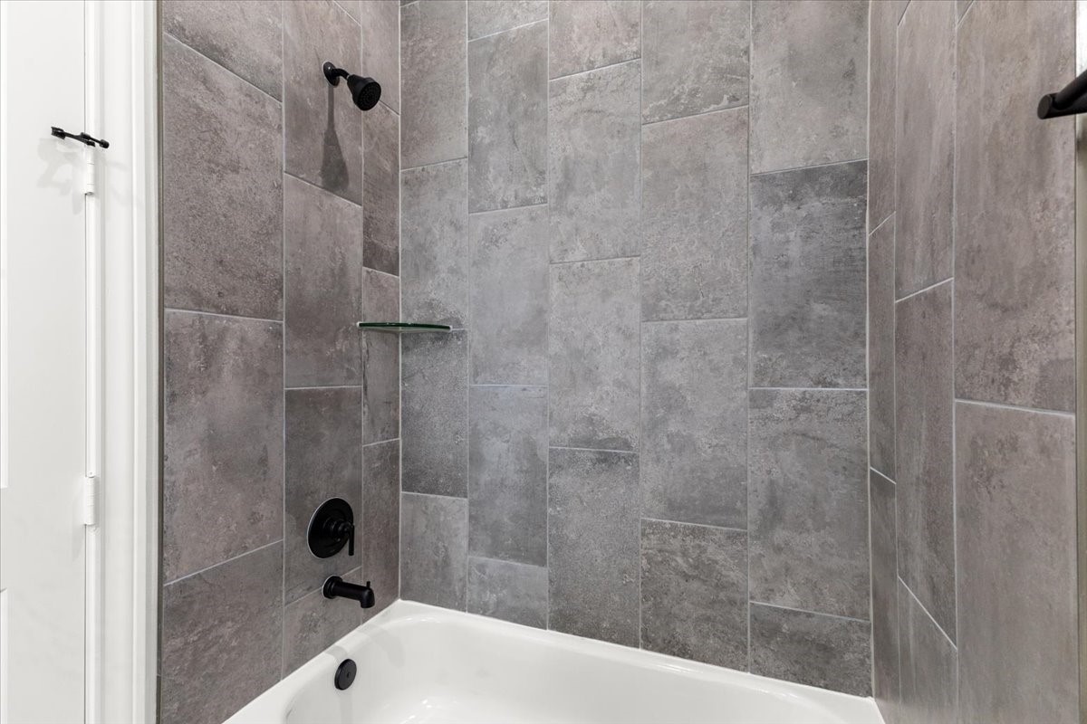 311 Tennessee Street Houston, TX 77029 - Photo 23 of 38 a bathroom with a bathtub and a shower