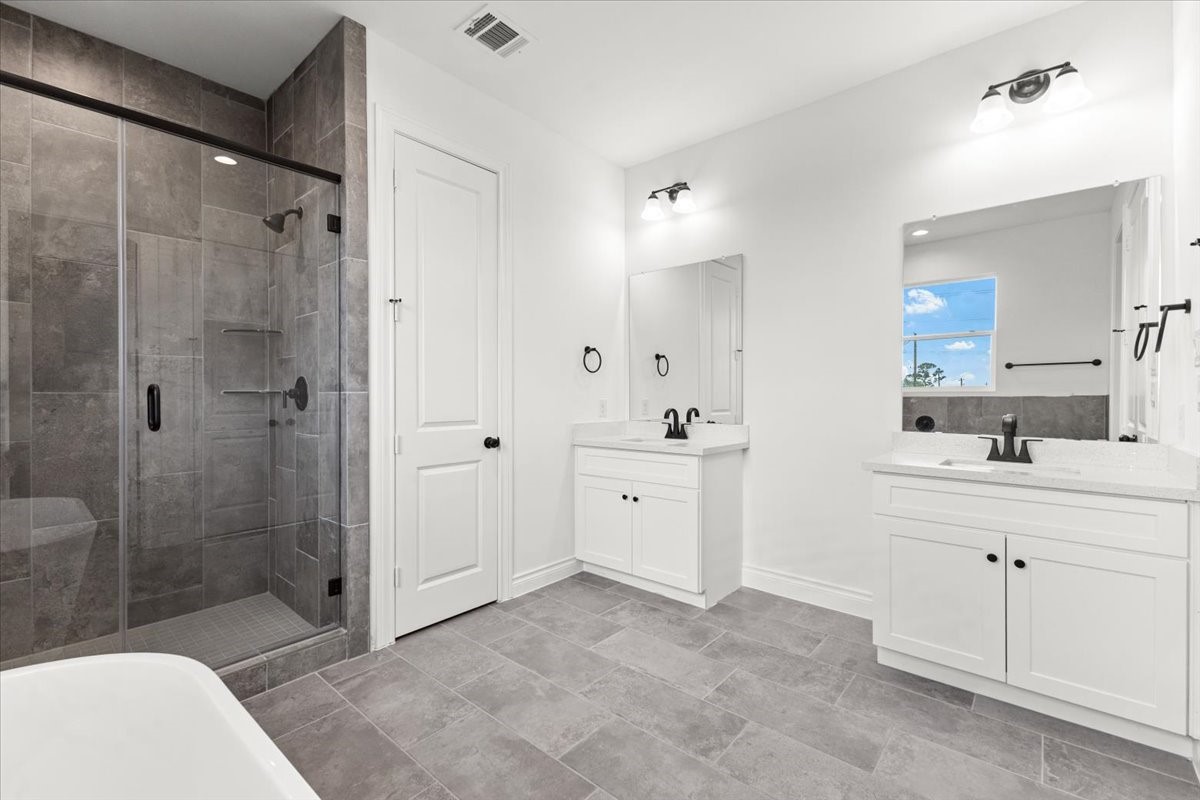 311 Tennessee Street Houston, TX 77029 - Photo 24 of 38 a spacious bathroom with a shower sink mirror and toilet