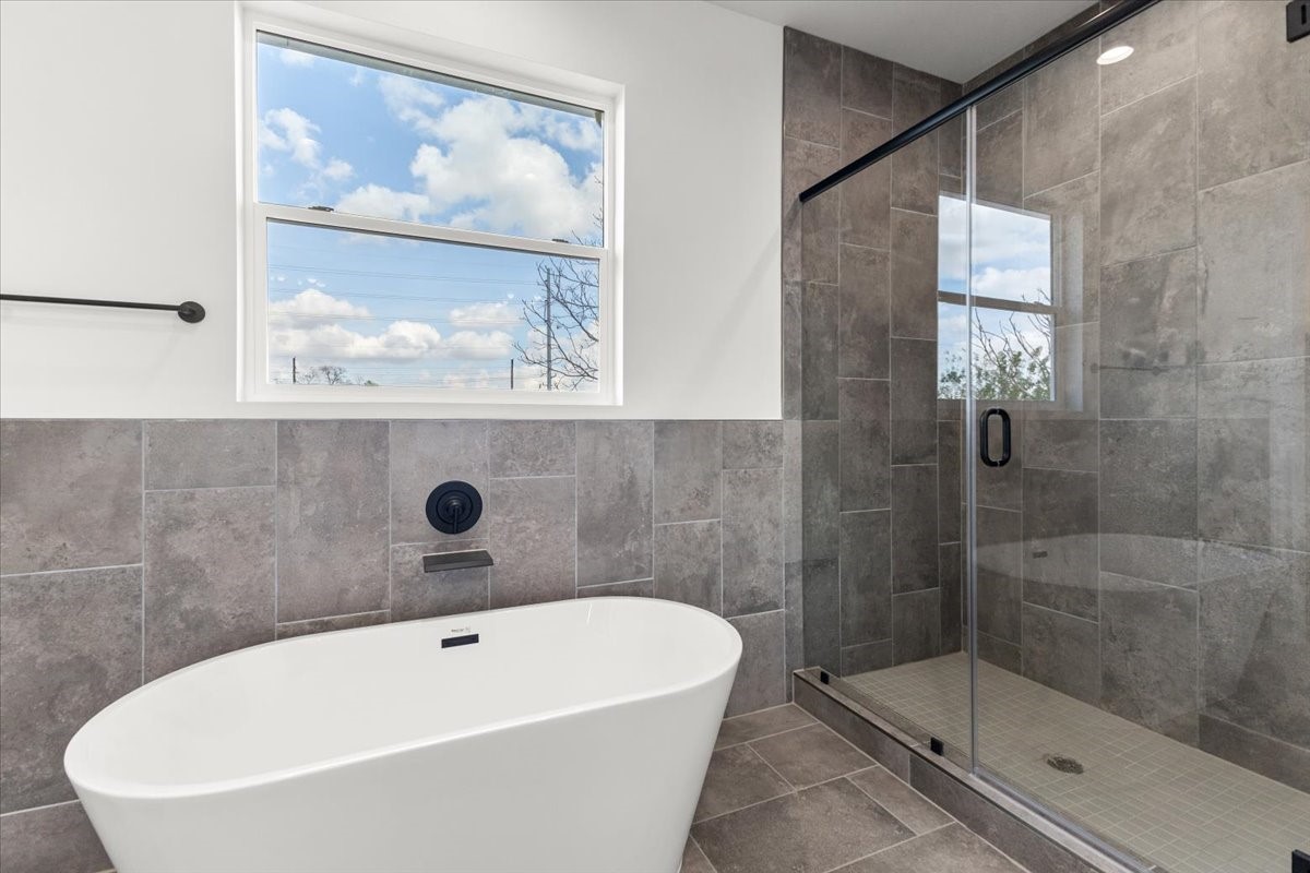 311 Tennessee Street Houston, TX 77029 - Photo 26 of 38 a white bath tub sitting next to a shower