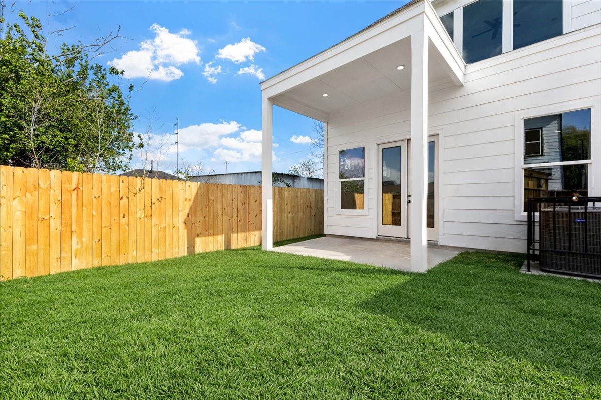 311 Tennessee Street Houston, TX 77029 - Photo 36 of 38 a view of a house with a yard and a large tree