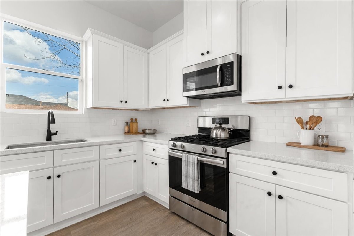 311 Tennessee Street Houston, TX 77029 - Photo 10 of 38 a kitchen with white cabinets and appliances