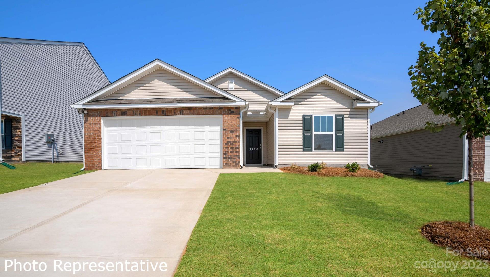 36 Burdock Road Fletcher, NC 28732 - Photo 1 of 18 a front view of a house with a yard and garage