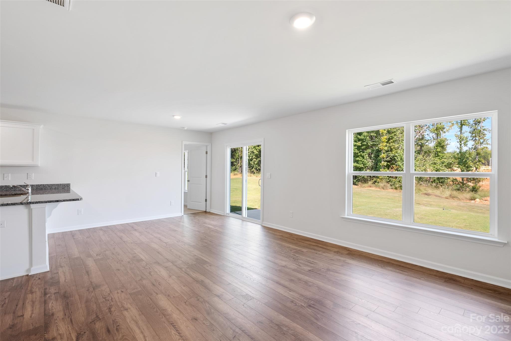 36 Burdock Road Fletcher, NC 28732 - Photo 12 of 18 a view of an empty room with a window and wooden floor