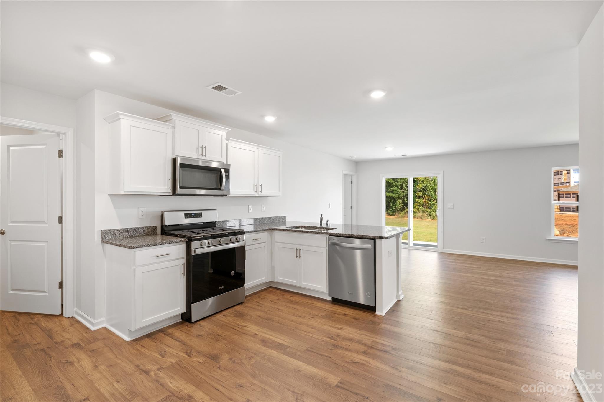 36 Burdock Road Fletcher, NC 28732 - Photo 6 of 18 a kitchen with granite countertop a stove top oven and sink
