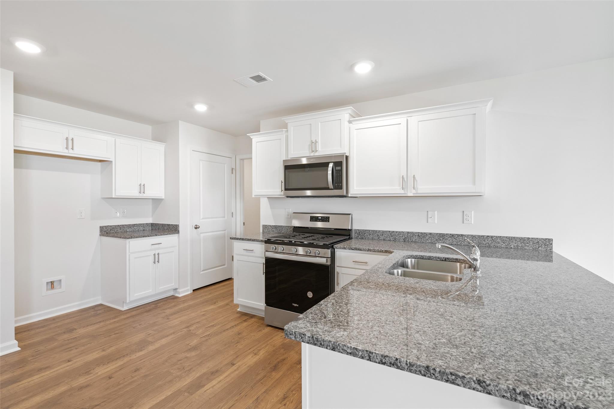 36 Burdock Road Fletcher, NC 28732 - Photo 8 of 18 a kitchen with granite countertop a stove top oven sink and cabinets