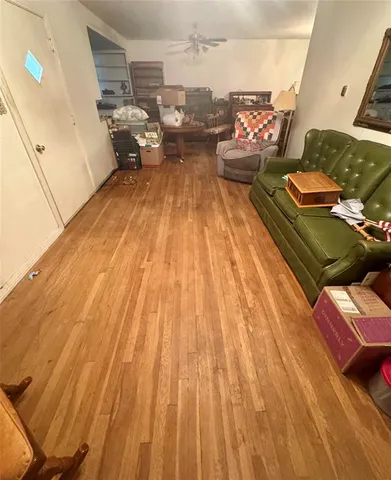 a living room with couch and wooden floor