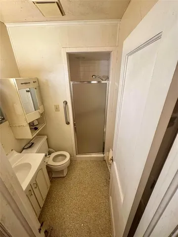 a bathroom with a toilet and a shower