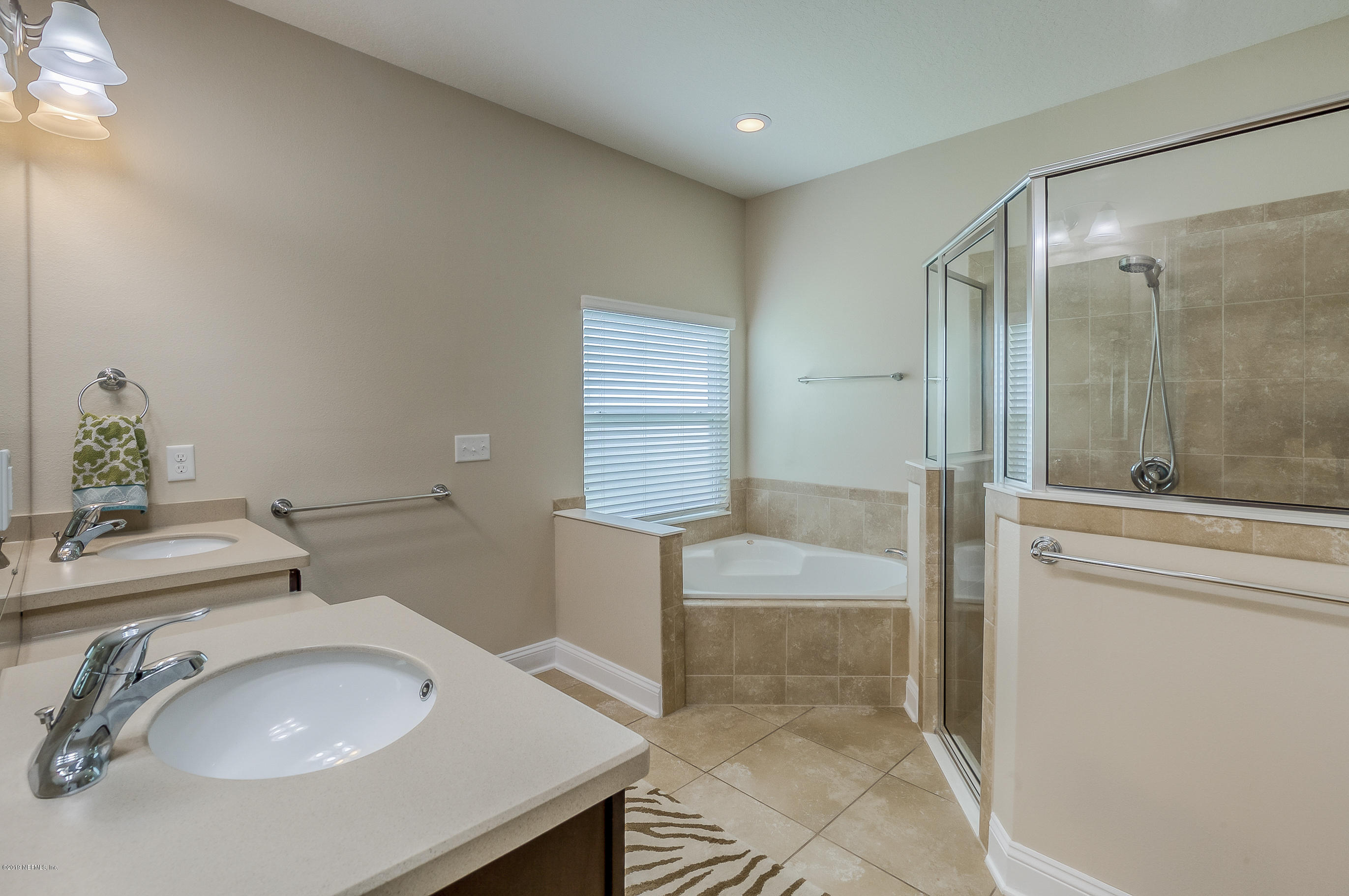 461 Irish Rose Road St. Augustine, FL 32092 - Photo 38 of 62 a bathroom with a sink and a mirror