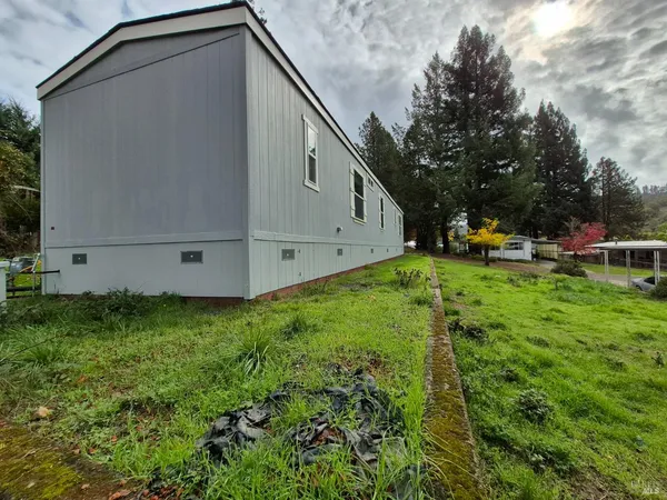 a view of a backyard with sitting area