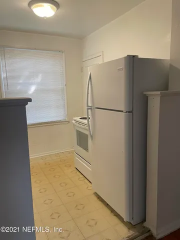 a white refrigerator freezer and a dishwasher in a kitchen