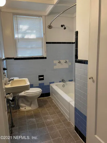 a bathroom with a toilet a sink and bathtub